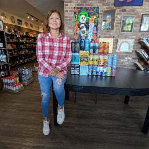 Carmen presenting Alarmist Le Jus Grayslake cans and fresh craft releases at Beer Bazaar.