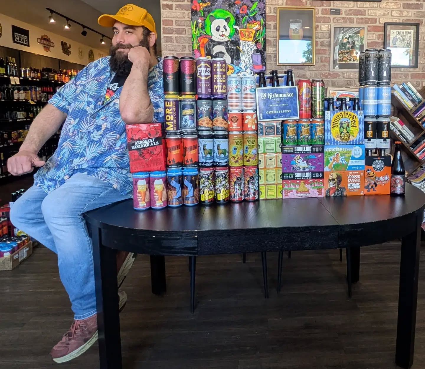 Nader displaying Pipeworks Ninja vs Unicorn Grayslake cans and fresh craft beer releases at Beer Bazaar.